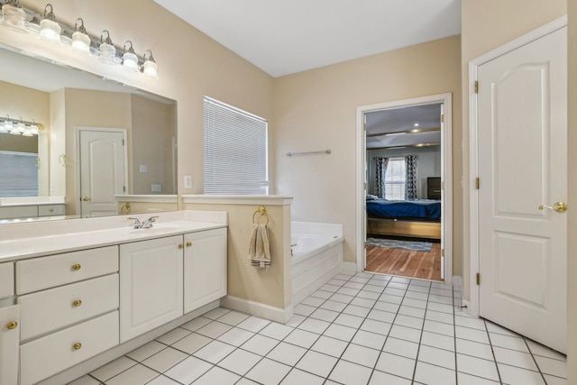 bathroom with vanity, a relaxing tiled tub, and tile patterned floors