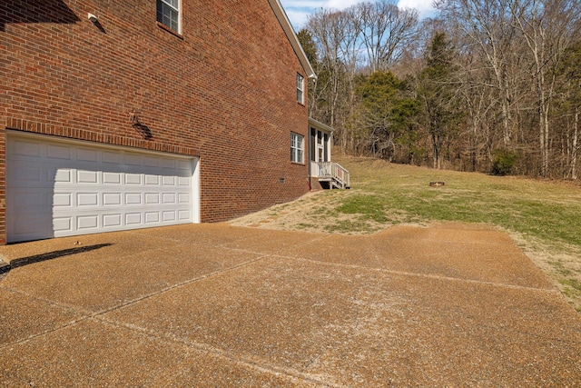 view of side of property with a garage and a yard