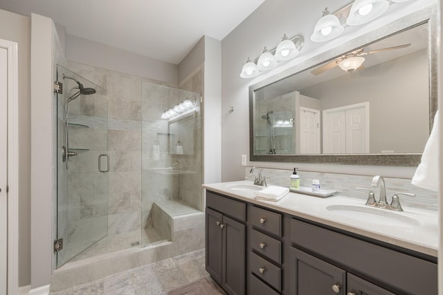 bathroom featuring vanity, ceiling fan, and a shower with shower door