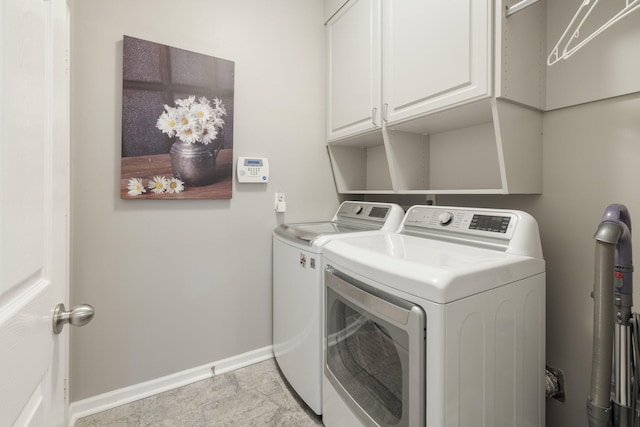 laundry area featuring cabinets and washer and clothes dryer