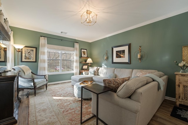 living room featuring hardwood / wood-style flooring, crown molding, and a chandelier