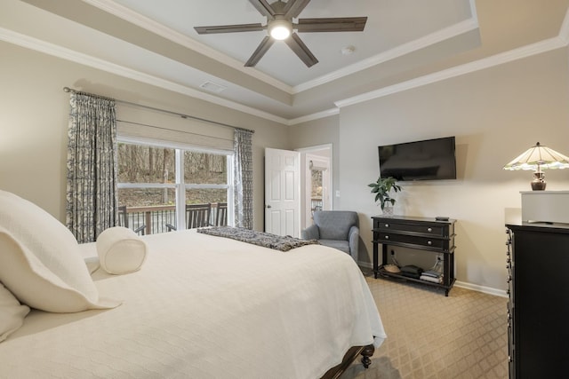 bedroom with crown molding, a raised ceiling, ceiling fan, and carpet flooring