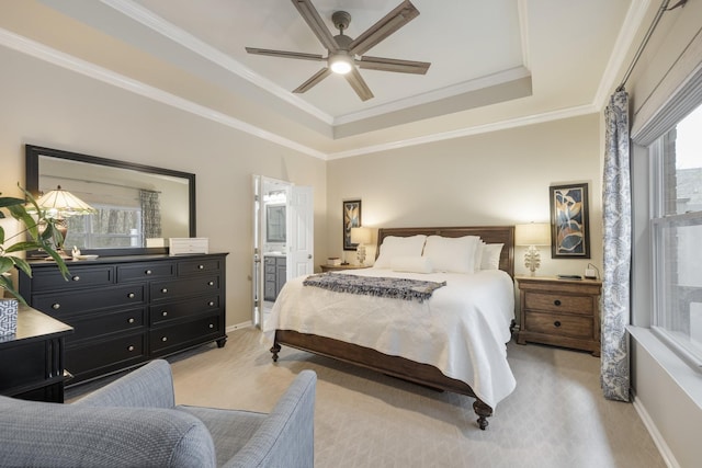 bedroom featuring crown molding, light colored carpet, ceiling fan, and a tray ceiling