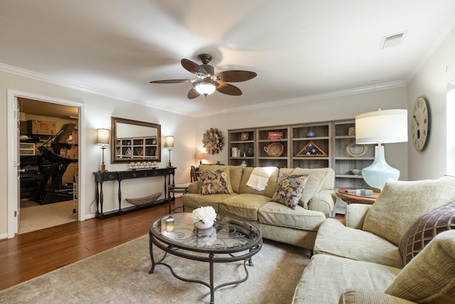 living room with crown molding, dark hardwood / wood-style floors, and ceiling fan