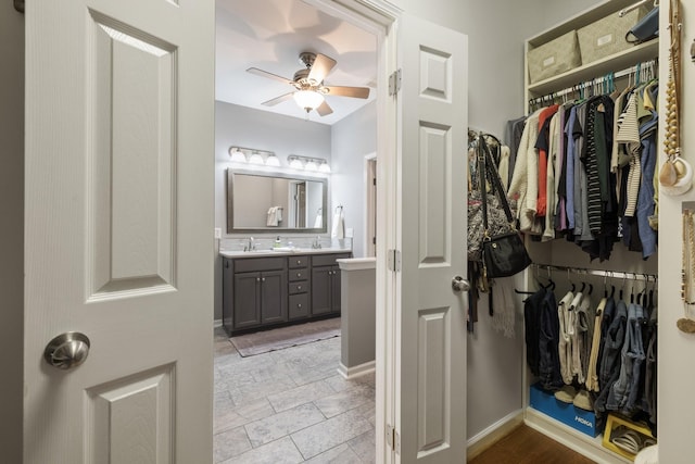 bathroom featuring ceiling fan and vanity