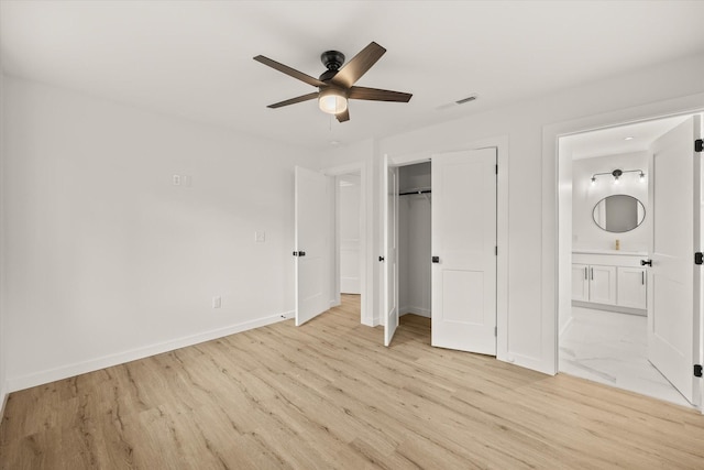 unfurnished bedroom with ensuite bathroom, ceiling fan, light hardwood / wood-style floors, and a closet