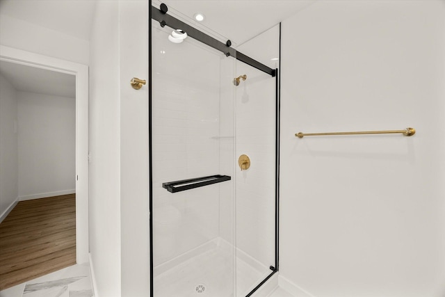 bathroom featuring a shower with shower door