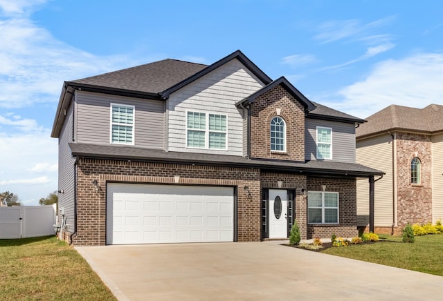 view of front of home with a garage and a front lawn