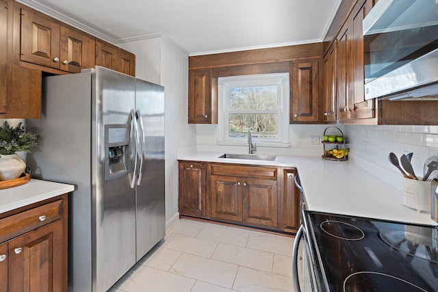 kitchen featuring tasteful backsplash, sink, crown molding, and stainless steel appliances