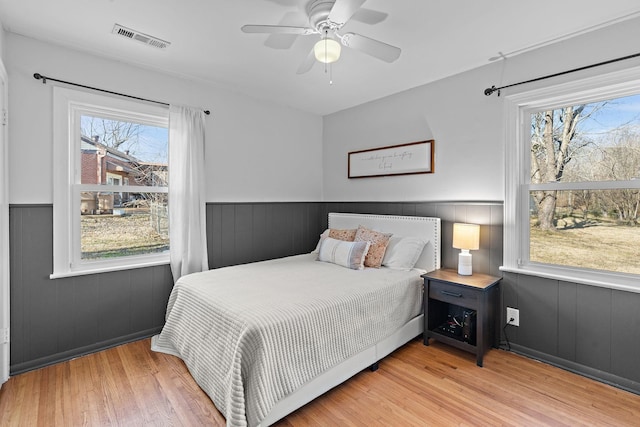 bedroom with light hardwood / wood-style floors and ceiling fan