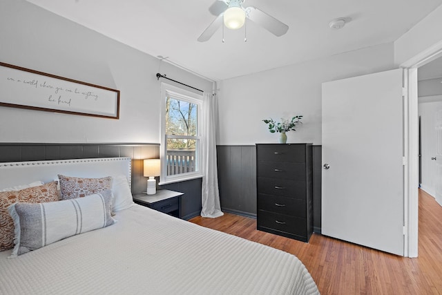 bedroom with ceiling fan and hardwood / wood-style floors