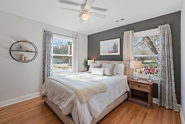 bedroom with ceiling fan and light hardwood / wood-style floors