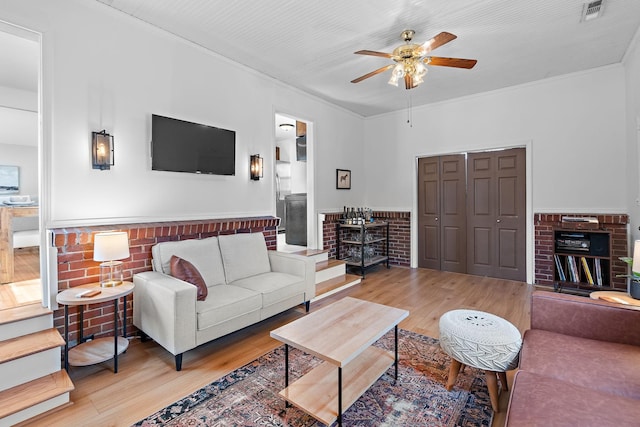 living room featuring ceiling fan and wood-type flooring