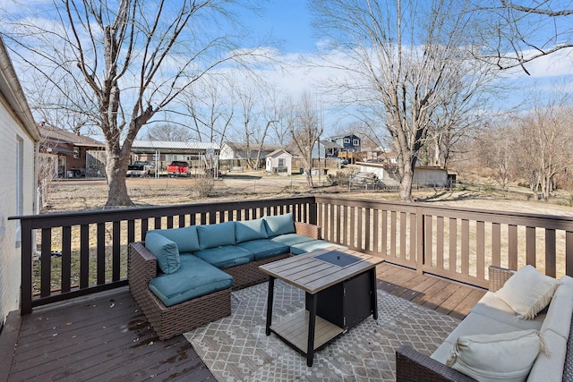 wooden terrace featuring an outdoor living space with a fire pit