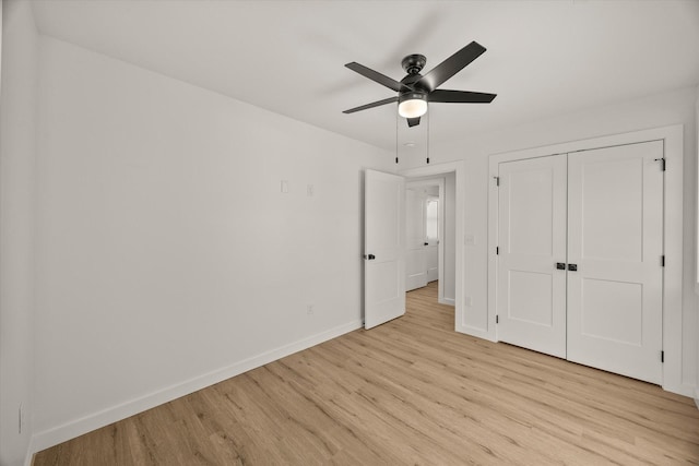 unfurnished bedroom with light hardwood / wood-style floors, a closet, and ceiling fan