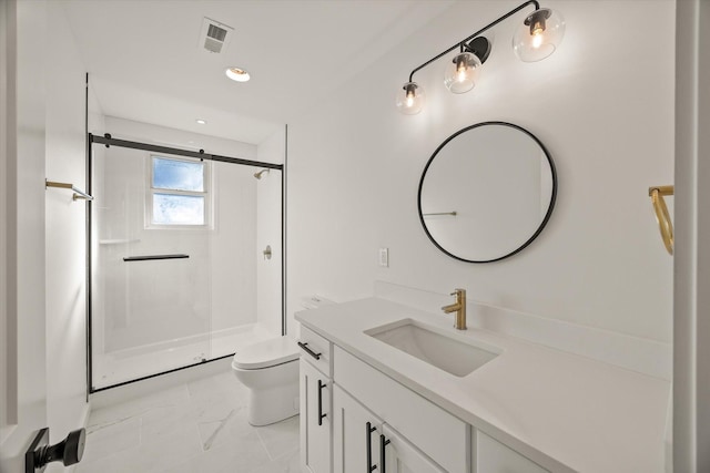 bathroom with a shower with door, vanity, and toilet