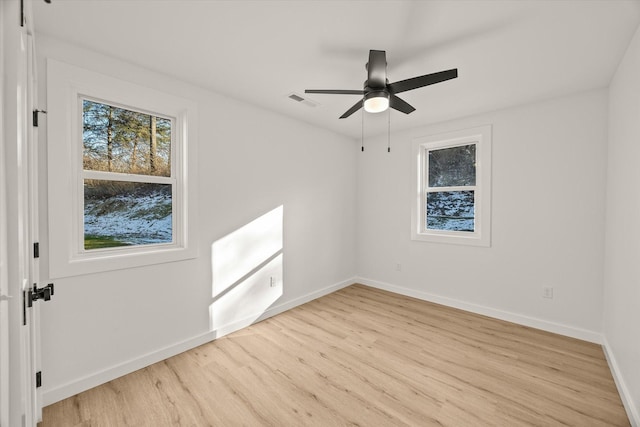 spare room featuring light hardwood / wood-style floors and ceiling fan