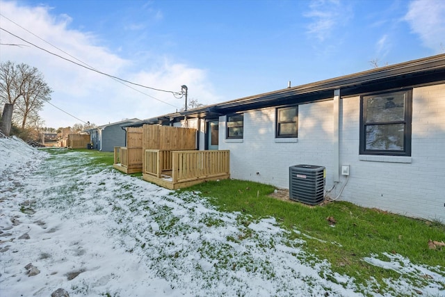 snow covered back of property with central AC unit