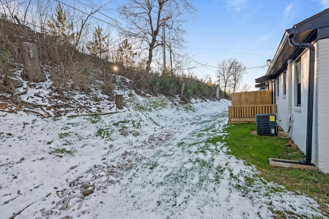 yard layered in snow featuring cooling unit