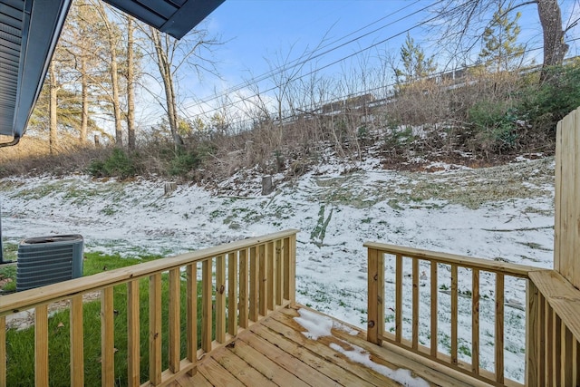 snow covered deck featuring central air condition unit