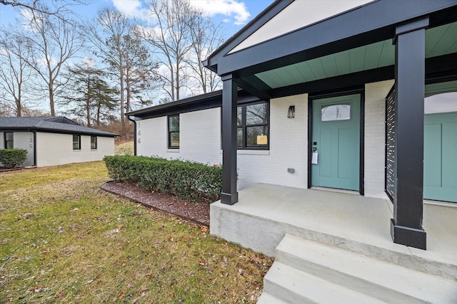 property entrance with a yard and a porch