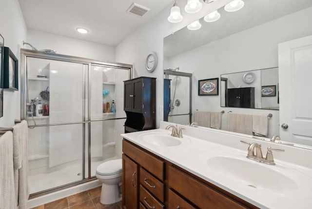 bathroom with walk in shower, vanity, toilet, and tile patterned flooring