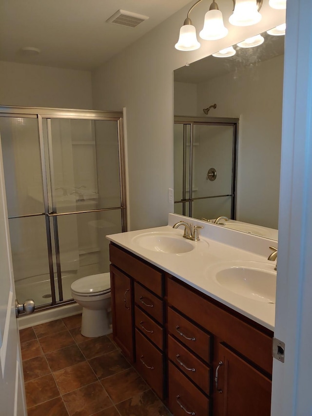 bathroom with vanity, tile patterned floors, toilet, and walk in shower