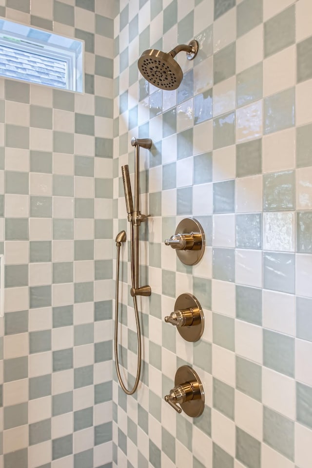 interior details featuring tiled shower