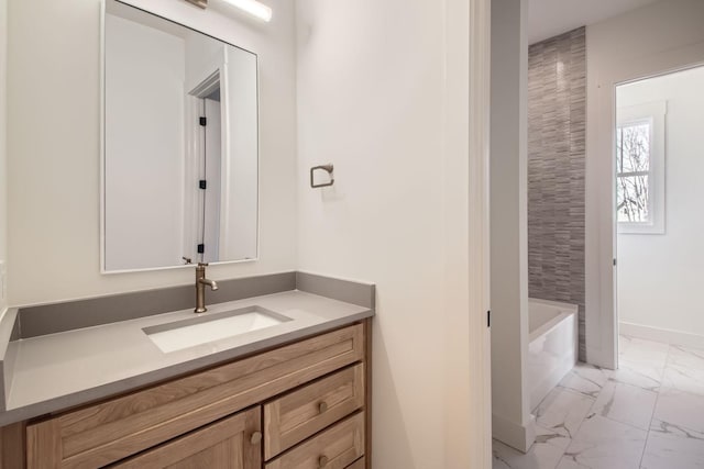 bathroom with vanity and a washtub