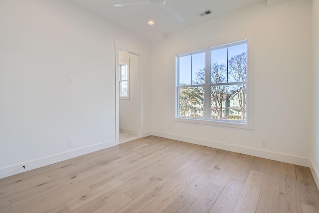 spare room with ceiling fan and light wood-type flooring