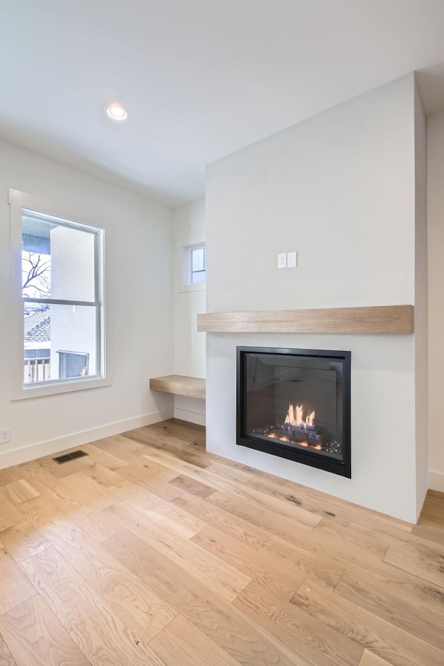 unfurnished living room featuring light wood-type flooring