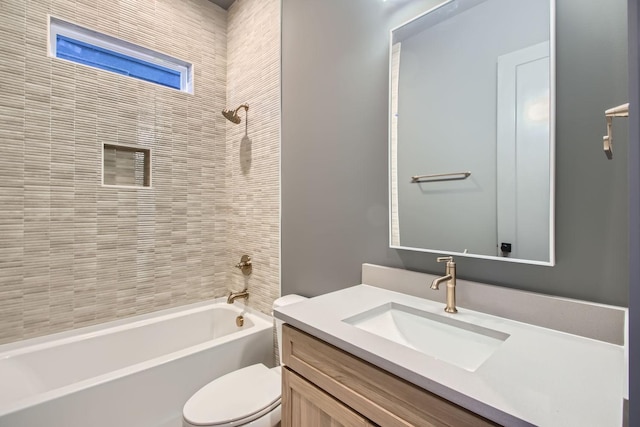 full bathroom featuring vanity, toilet, and tiled shower / bath combo