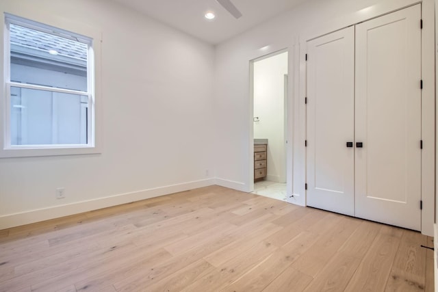 unfurnished bedroom featuring light hardwood / wood-style floors and a closet