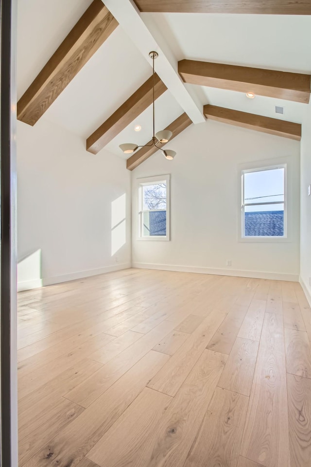 interior space with light hardwood / wood-style floors and vaulted ceiling with beams