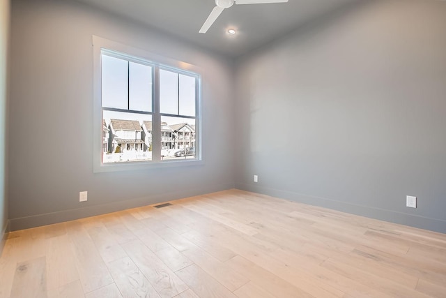 unfurnished room with ceiling fan and light hardwood / wood-style floors