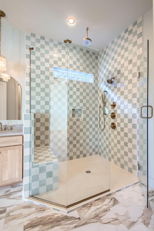 bathroom featuring vanity and a shower with door