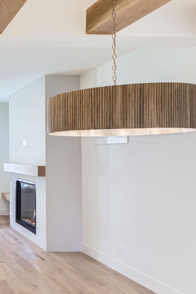 interior details with beamed ceiling and hardwood / wood-style floors