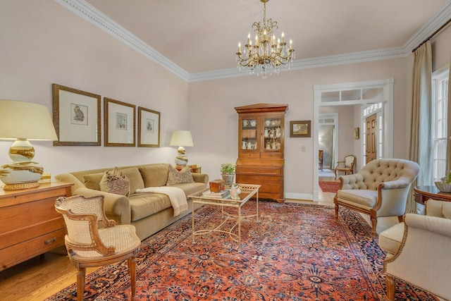 living room featuring hardwood / wood-style flooring, crown molding, plenty of natural light, and a notable chandelier