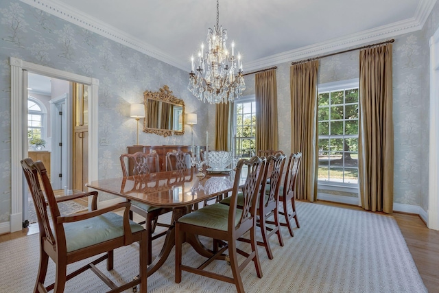 dining area featuring ornamental molding, a chandelier, and light hardwood / wood-style floors