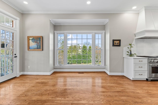 foyer entrance with crown molding and light wood-type flooring