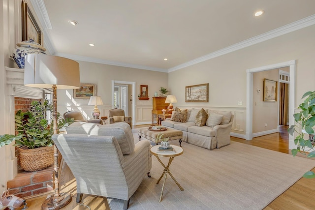 living room with crown molding and light hardwood / wood-style floors