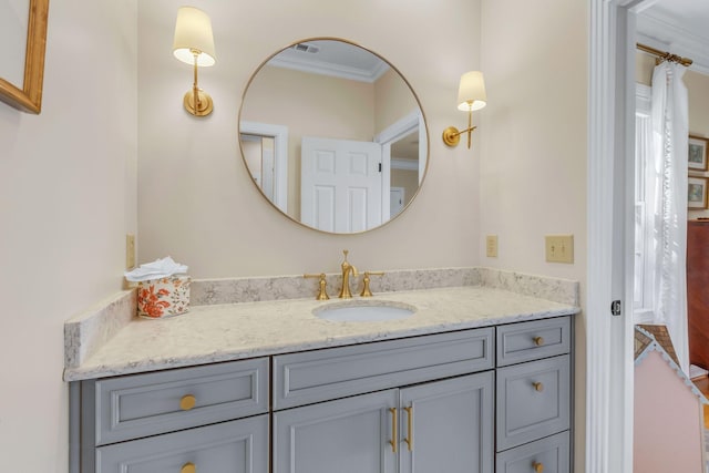 bathroom with vanity and ornamental molding