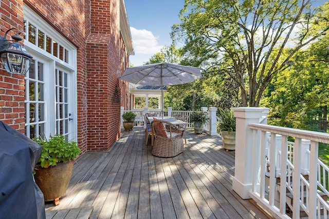 wooden terrace with a grill