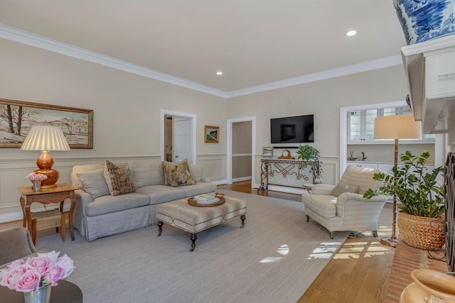 living room with crown molding and light hardwood / wood-style flooring