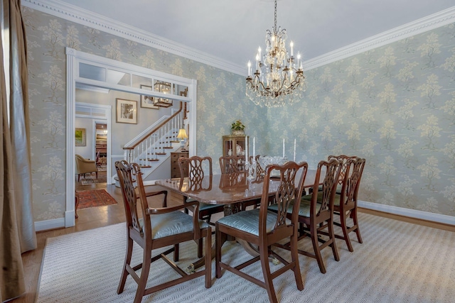 dining room featuring a notable chandelier, crown molding, and light hardwood / wood-style floors