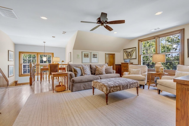 living room featuring light hardwood / wood-style flooring, ceiling fan, and vaulted ceiling