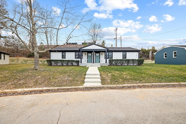 ranch-style home with a porch and a front yard