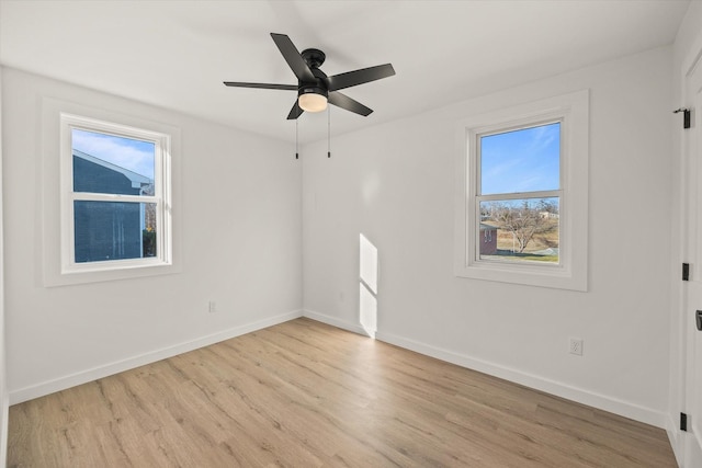 unfurnished room featuring ceiling fan, plenty of natural light, and light wood-type flooring