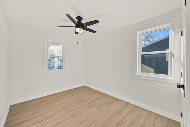 empty room featuring ceiling fan, a healthy amount of sunlight, and light hardwood / wood-style floors