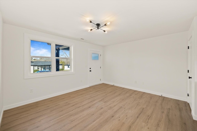 unfurnished room with light wood-type flooring